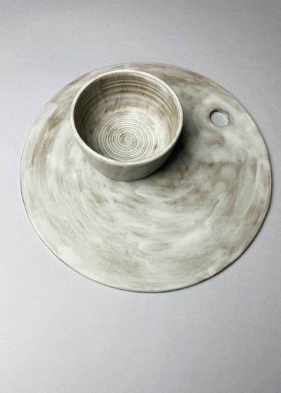 Grey-white ceramic board set with a bowl