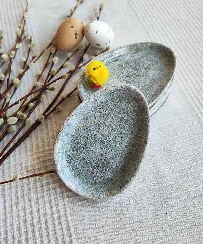 Small speckled ceramic egg-shaped plates